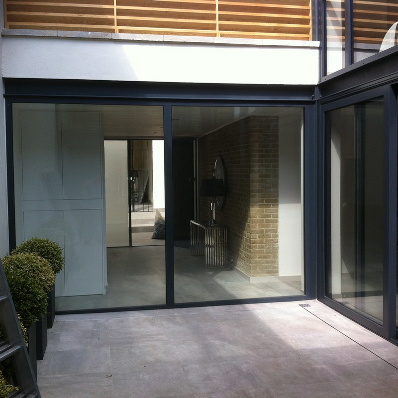 Floor-to-ceiling sliding doors opening to courtyard in Greenwich