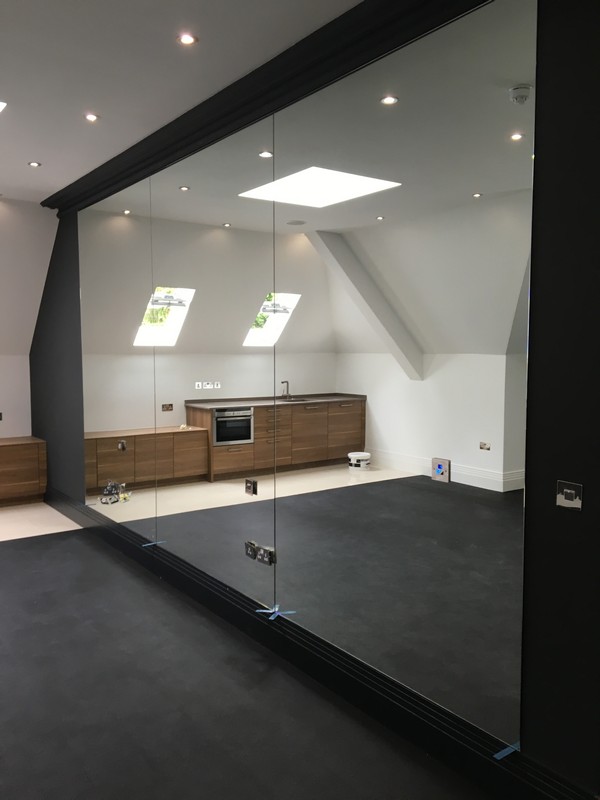 Frameless glass partition in loft conversion by Greenwich glaziers