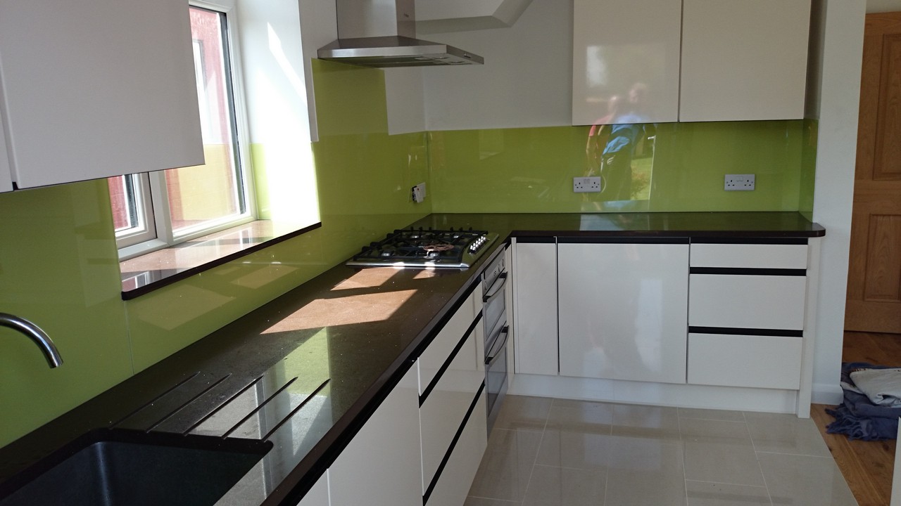 Lime green glass kitchen splashback installed by Greenwich glaziers