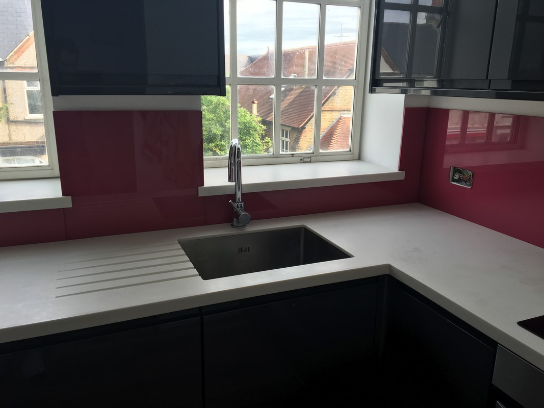 Deep plum coloured glass splashback in modern Greenwich kitchen